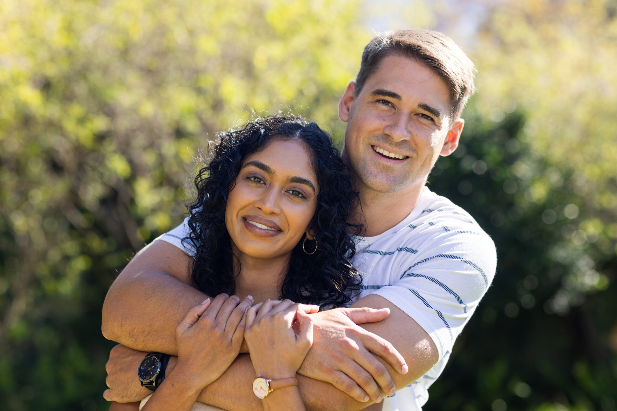 Couple smiling outside their home